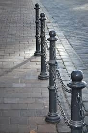 A bollard is a sturdy, short post designed to manage or guide road traffic.